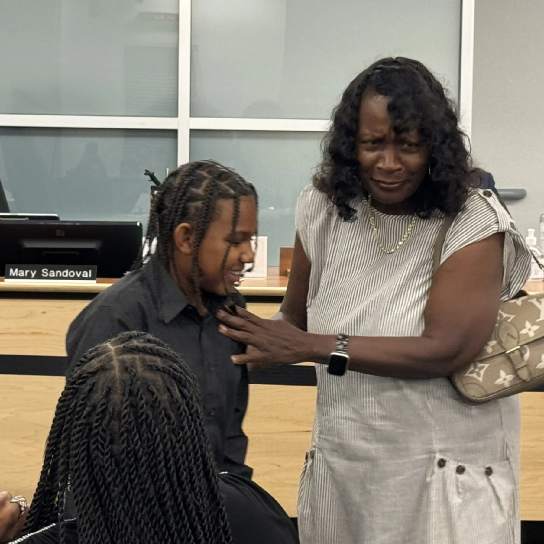 Cyrus Moss with community member at school board